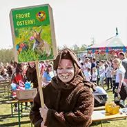 Easter Woman in rabbit costume with sign